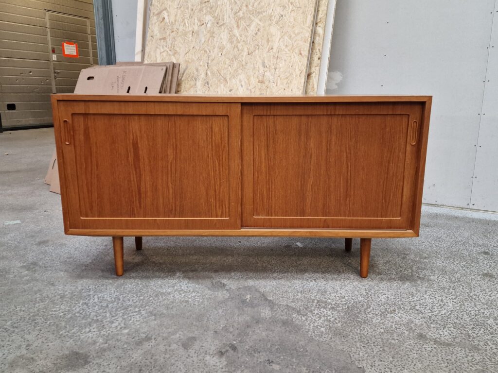 Mid-century modern teak sideboard with sliding doors.