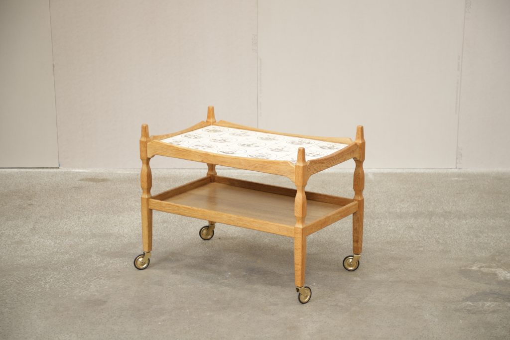 Mid-century modern serving cart with tile top for kitchen and dining.