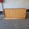 Mid-century modern oak sideboard with sliding doors.