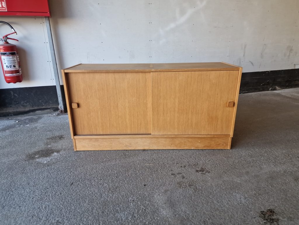 Mid-century modern oak sideboard with sliding doors.