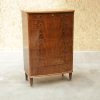 Vintage walnut chest of drawers with seven drawers and brass pulls.