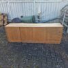 Mid-century modern wooden sideboard with sliding doors.