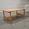 Simple light oak wood table with minimalist legs.