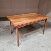 Classic wooden table with smooth surface and tapered legs.